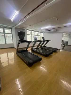 a row of treadmills in a gym with wooden floors at Antel Spa Residences 1703 in Manila