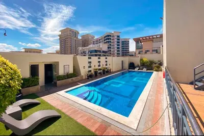 a swimming pool on the balcony of a apartment at Stamford Executive Residences, McKinley Hill in Manila