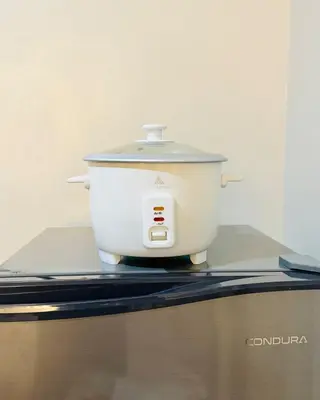 a slow cooker sitting on top of a counter at Cozy Modern Condo in Little Baguio Terraces San Juan City in Manila