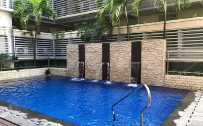 a large swimming pool with a hose in front of a building at Your Home Suite at 150 Newport Boulevard Condo near NAIA T3 in Manila