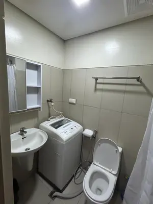 a small bathroom with a toilet and a sink at CG Staycation Hub in Manila