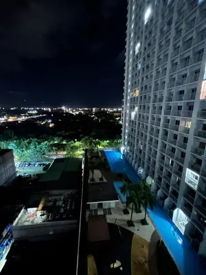 a view of a tall building at night at CG Staycation Hub in Manila