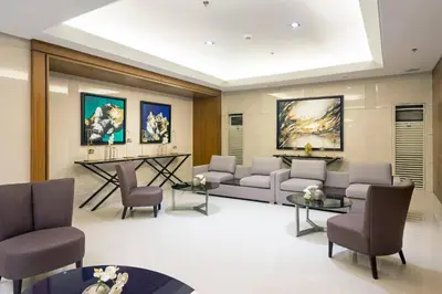 a living room with a couch and chairs and tables at CG Staycation Hub in Manila