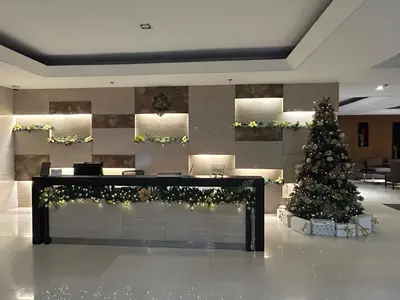 a christmas tree in the middle of a lobby at CG Staycation Hub in Manila