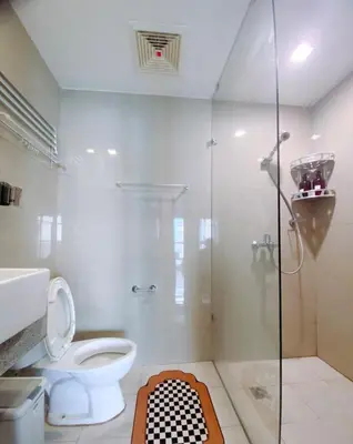 a bathroom with a toilet and a glass shower at 120 Sqm 3Bedrooms Facing Manila Bay Sunset, Airports, Okada, Solaire, MOA, free parking in Manila