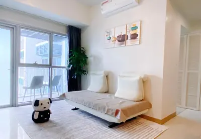 a living room with a couch and a large window at 120 Sqm 3Bedrooms Facing Manila Bay Sunset, Airports, Okada, Solaire, MOA, free parking in Manila