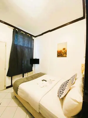 a bedroom with a bed and a window in it at Makati Avenue Suites in Manila