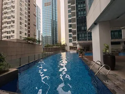 a swimming pool in the middle of a building with tall buildings at Japandi Haven with Uptown Mall Fountain View One Uptown BGC in Manila