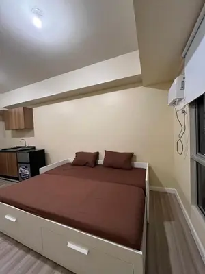 a bedroom with a large bed in a room at Staycation Condotels RD in Manila