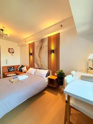 a hotel room with two beds and a couch at Stunning 41F Skyline View Relaxing City Escape in Manila