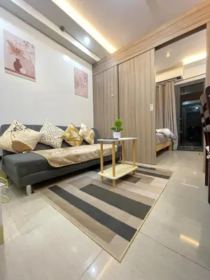a living room with a couch and a table at H&M staycation SHORE 2 in Manila
