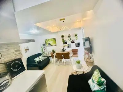 a living room with a couch and a table at Cozy Condos at Azure Urban Resort in Manila