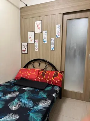 a bedroom with a bed and a door with notes on the wall at Shore Homestay in Manila