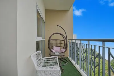 a balcony with two chairs and a wicker chair at Luxury Home near Solaire and Okada Manila in Manila