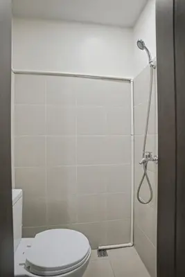 a bathroom with a toilet and a shower at Luxury Home near Solaire and Okada Manila in Manila