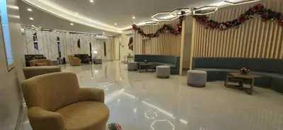 a lobby with couches and chairs in a building at Quantum Residences in Manila