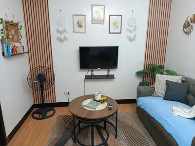 a living room with a couch and a table at Chic Haven Home away from home in Imus