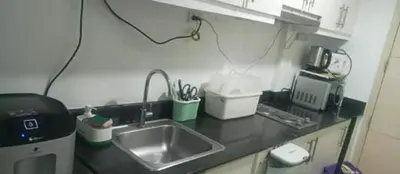 a kitchen counter with a sink and a microwave at Sea Residence 2026 in Manila
