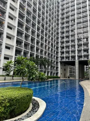 a large apartment building with a large swimming pool at 3Ms Homestay Shore in Manila