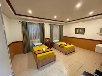 a hotel room with two beds in it at Palette Gems Hotel and Conference Center in Quezon City