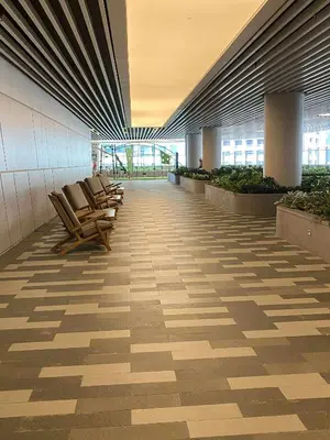 a row of chairs sitting in a hallway in a building at Stylish 1BR Air Residences Wifi & Netflix in Manila