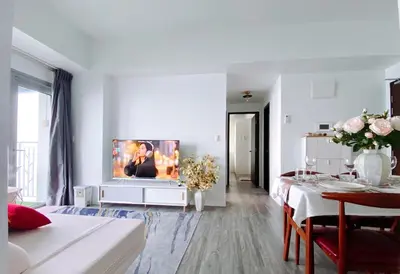 a white living room with a tv on a white wall at 2BR Luxurious Ocean View, close Okada, Solaire, MOA, Airport with free parking in Manila