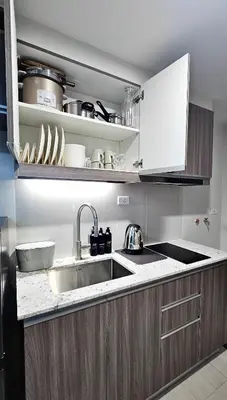 a kitchen with a sink and a counter top at Park Mckinley West Luxury 1Br Suite in Manila