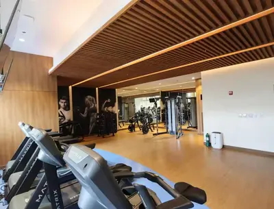 a gym with treadmills and cardio equipment in a building at Park Mckinley West Luxury 1Br Suite in Manila