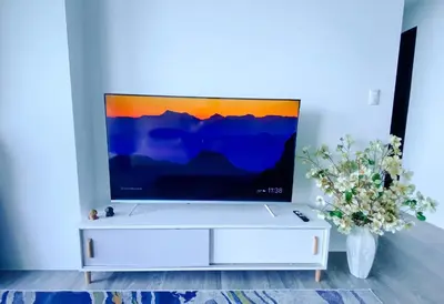 a white entertainment center with a flat screen tv on top at 2BR With Magnificent Bayview GARDEN View Near Okada, Solaire, Airports, Free Parking in Manila