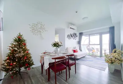 a living room with a christmas tree and a table at 2BR With Magnificent Bayview GARDEN View Near Okada, Solaire, Airports, Free Parking in Manila