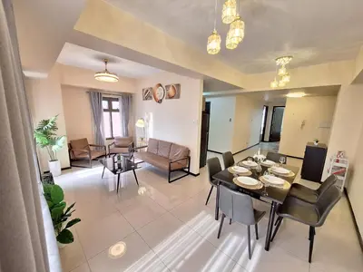 a living room with a table and chairs and a couch at GOUTEI Homestay - The Radiance Manila Bay in Manila