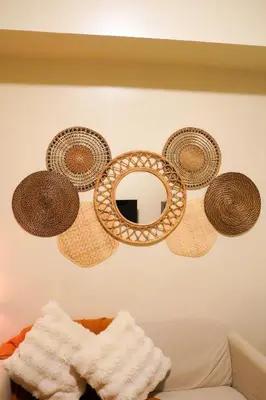 three baskets hanging on a wall with a mirror at SMDC LIGHT Balcony Smart TV Alexa Cozy Retreat in Manila
