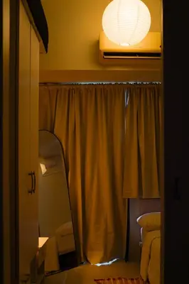 a mirror in a room with a window and a light at SMDC LIGHT Balcony Smart TV Alexa Cozy Retreat in Manila