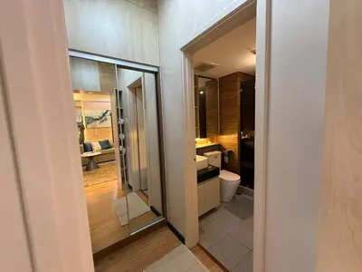 a bathroom with a sink and a toilet in a room at 2BR Near Manila Bay MOA l Airport with FREE use of Pool l 4 PPL in Manila