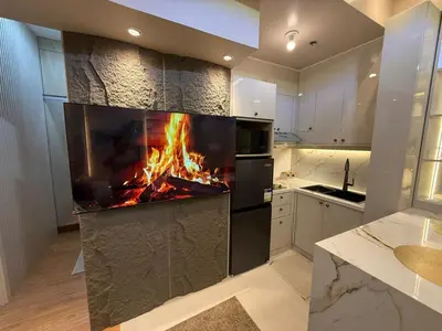 a kitchen with a fireplace in the middle at 2BR Near Manila Bay MOA l Airport with FREE use of Pool l 4 PPL in Manila