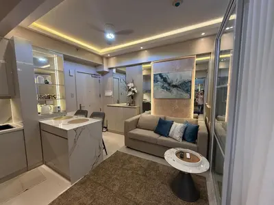 a living room with a couch and a table at 2BR Near Manila Bay MOA l Airport with FREE use of Pool l 4 PPL in Manila