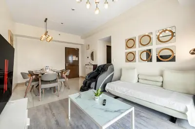 a living room with a white couch and a table at Seaview 2BR CondoteI Near Airport,NAIA, MOA ,Okada Casino in Manila