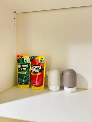 a shelf with two cans of toothpaste and a candle at Shore Balcony MOA Price worthy Wifi Pool Netflix in Manila