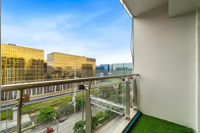 a balcony with a view of a city at Cozy Family Suite with City View near City of Dreams Casino, Airport, Solaire, Okada, Ayala Malls and MOA in Manila
