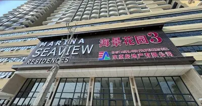 a sign on the side of a building at Sy bay suites near PITX NAIA Airport T3 MOA Okada MSV2107 in Manila