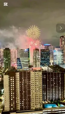 a fireworks display over a city with tall buildings at Entire 2BR apartment in BGC in Manila