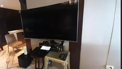 a large flat screen tv hanging on a wall at Shell Residences Condominium Philippines, Manila, Pasay City in Manila