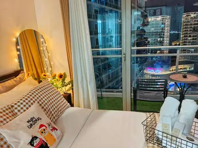 a bedroom with a bed with a view of a city at Vacation in Harmony in Manila