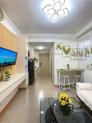a living room with a couch and a table at Transient Home Lancin in Manila