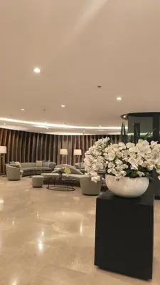 a lobby with two large vases filled with white flowers at Urban Haven Manila in Manila
