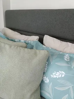 a bed with two pillows on top of it at The Atherton Condominium 1 Bedroom Staycation in Manila