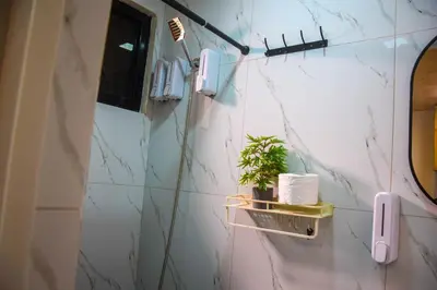 a bathroom with a wall with a phone and a plant at CLBC Residences New home in the heart of Laguna in Biñan