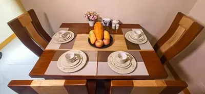 a wooden table with carrots and plates on it at CLBC Residences New home in the heart of Laguna in Biñan