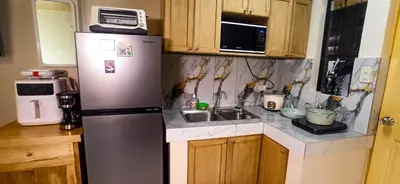 a kitchen with a refrigerator and a sink at CLBC Residences New home in the heart of Laguna in Biñan