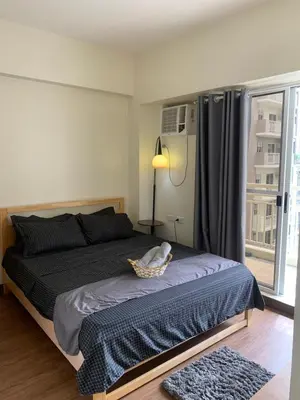 a bedroom with a bed with a basket on it at 2BR 38th flr SIESTA SPACE in PRISMA Residences in Manila
